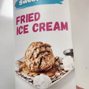 a hand holding a can of fried ice cream