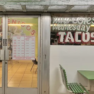 a man standing in front of a restaurant