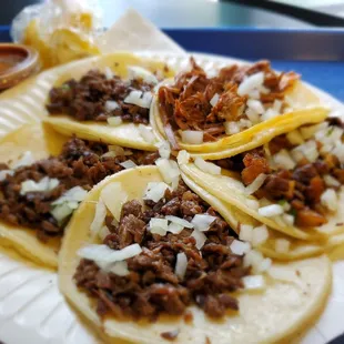 Three carne asada, birria and al pastor tacos