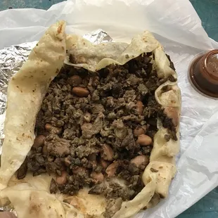 a hand holding a pita