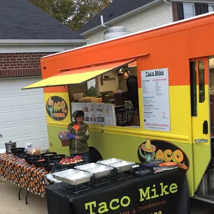 a man standing in front of a food truck