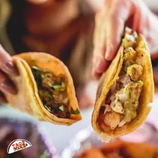 a person holding a taco