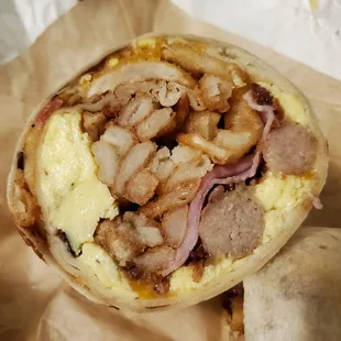 Meatallica Brunch Burrito has bacon, sausage, ham, scrambled eggs, cheese, and seasoned fries in it!