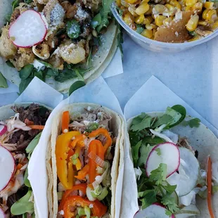 A smorgasbord board of OG tacos and corn