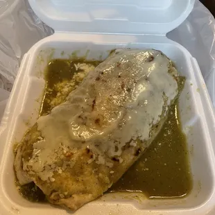 Wet burrito with green sauce topped with cheese!