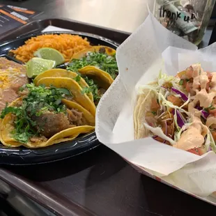 Taco plate with Rice and beans and a fish taco.