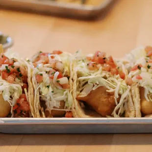 a tray of tacos on a table