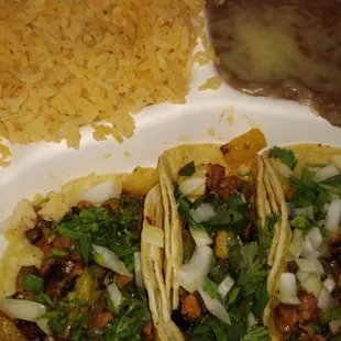 two tacos and rice on a plate