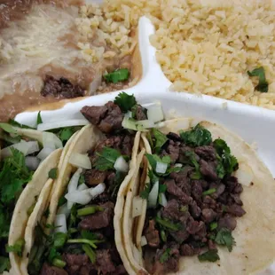 a plate of tacos and rice