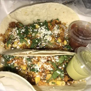 Two Leo tacos w/ a cup of each side sauce