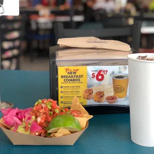 a cup of coffee and a bowl of nachos