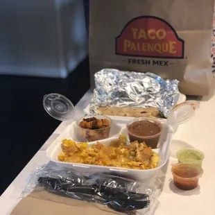 Chilaquiles plate with potatoes and refried beans. Yum!