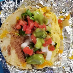 Breakfast pirata dressed with requested salsa bar toppings (green sauce, cilantro, lime, pico de gallo)