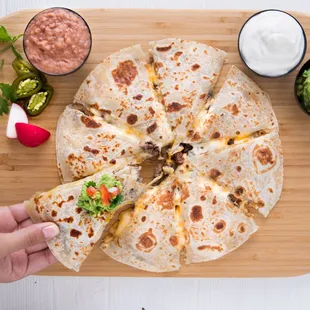 a hand holding a tortilla