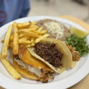 Choice of three tacos and side of French fries and refried beans