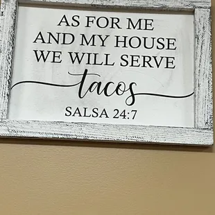 a sign saying as for me and my house we will serve tacos salsa