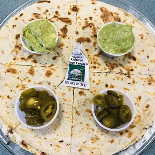a tortilla with pickles and guacamole