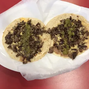 two tortillas on a red table