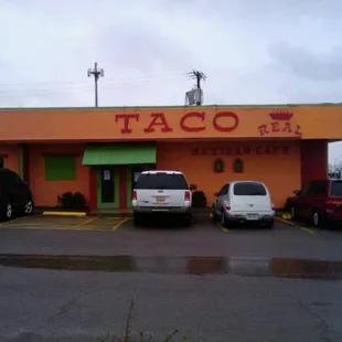cars parked in front of a taco restaurant