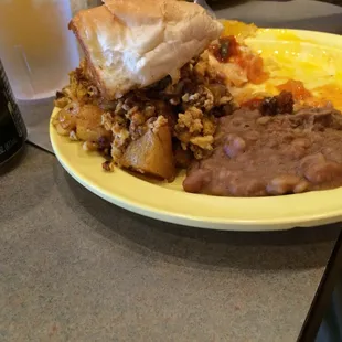 a plate of mexican food and a soda