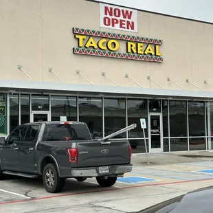 a pickup truck parked in front of a restaurant