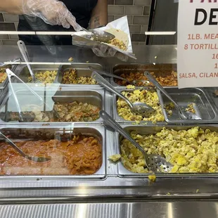 a person serving food at a buffet