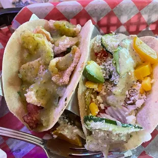 two tacos on a tray with a fork