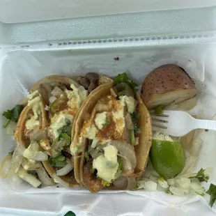 two tacos in a styrofoam container