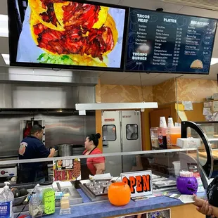 a woman ordering food at a restaurant