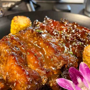 a plate of ribs and corn