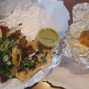 two tacos and chips on a table