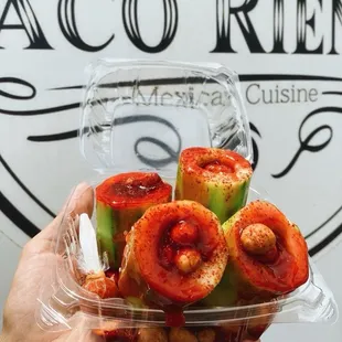 a person holding a container of food