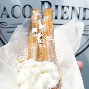 a hand holding a pastry