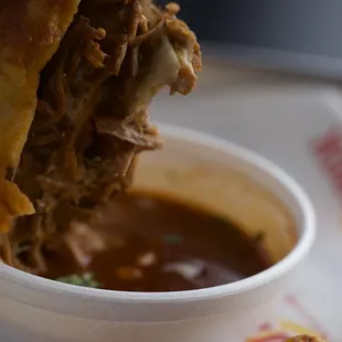 Birria Crunch wrap supreme. Copious amounts of white onions so I didn&apos;t like it but the BF loved it!