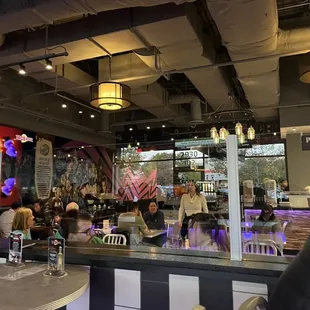 people sitting at tables in a restaurant