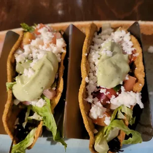 Tacos with overcooked shell and burnt chicken