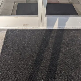a doormat on the sidewalk
