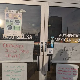 signs on the door of a mexican restaurant