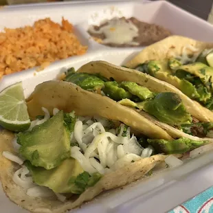 Taco plate.  Barbacoa, shredded beef &amp; shredded chicken with Avocado slices , cilantro, onions, Salsa verde sauce &amp; mozzarella cheese.
