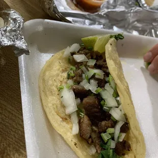 Steak taco with cilantro and onion