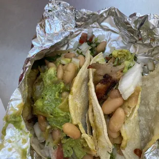 two tacos wrapped in foil