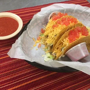 a plate of tacos and a bowl of salsa