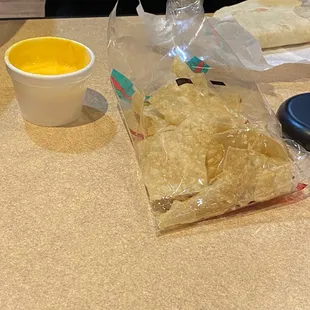 House-made queso and a bag of tortilla chips