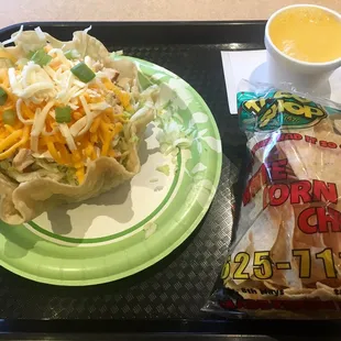 a plate of food and a bag of chips