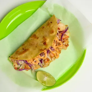 a tortilla on a green plate