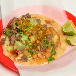 a taco with meat and vegetables on a red plate