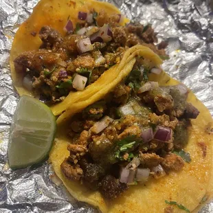 Al pastor Tacos w/ red salsa on one and green salsa on the other