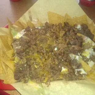 Super nachos are super loaded with steak!