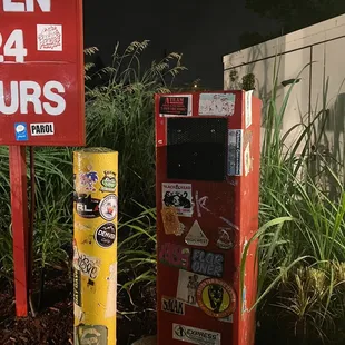 a red vending machine and a yellow vending machine