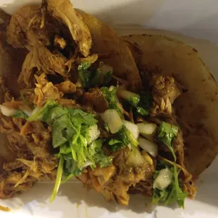 a close up of a taco with meat and vegetables